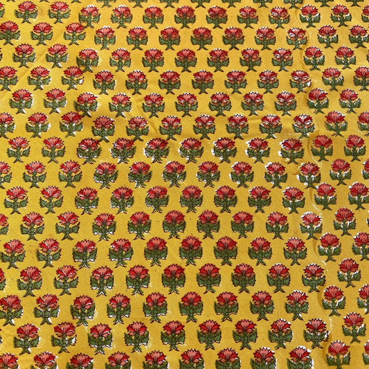 Pattern of red flowers with green stems on a yellow background