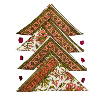 Set of triangular fabric coasters with floral patterns on a white background