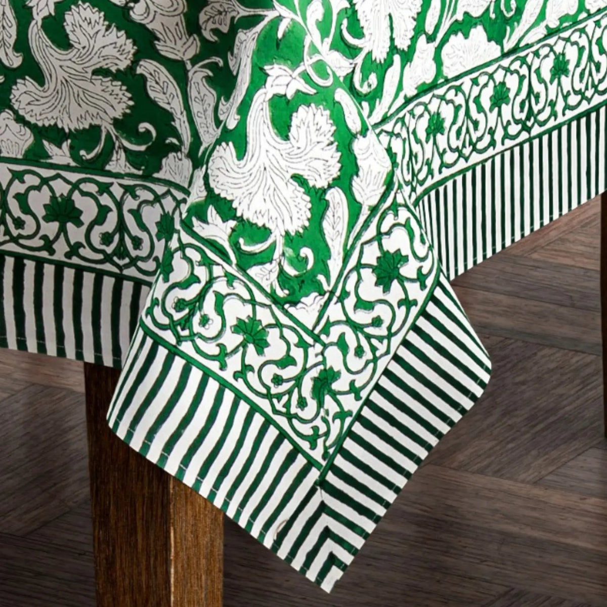 Green and white patterned tablecloth on a wooden table