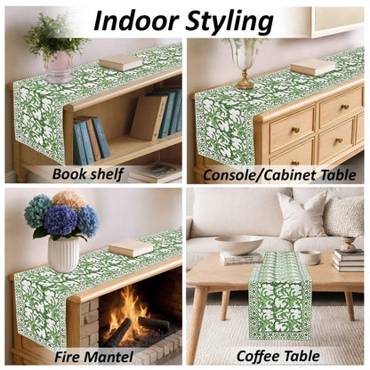 Green floral table runner displayed on various furniture items including a bookshelf, console cabinet, fire mantel, and coffee table.