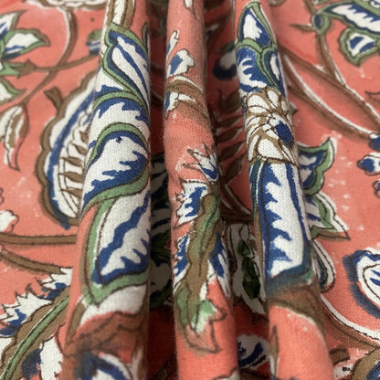Close-up of patterned fabric with intricate design on a pink background
