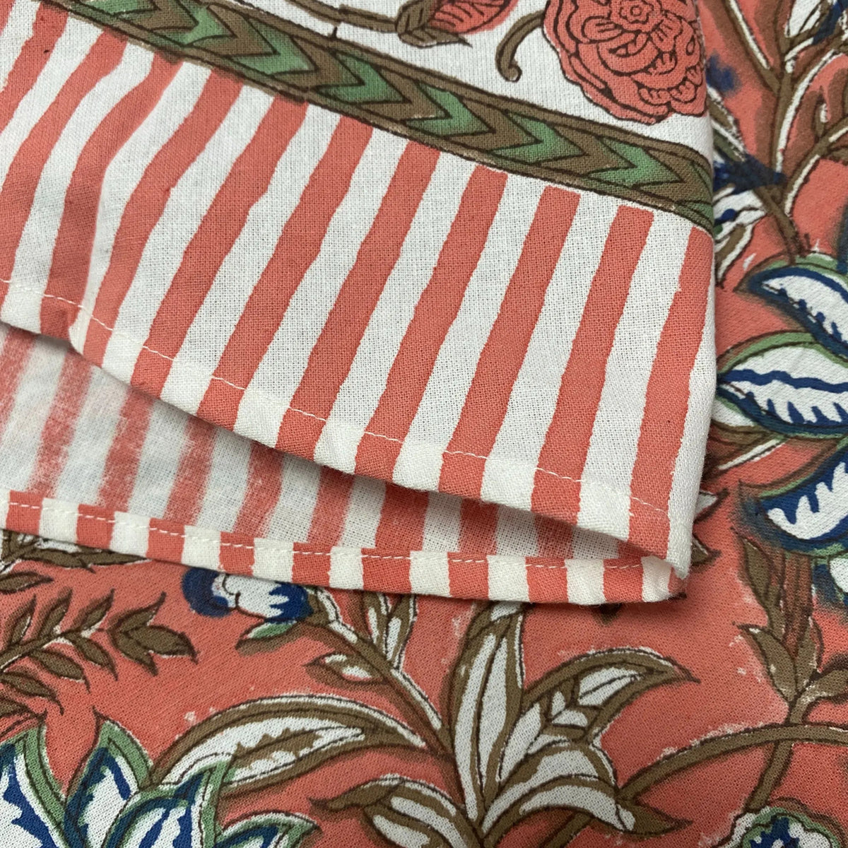 Close-up of striped fabric with floral patterns in the background