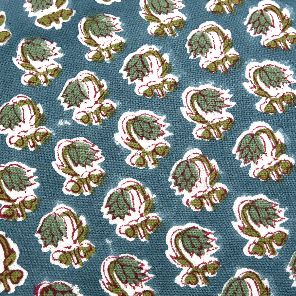Pattern of green and red leaves on a blue background