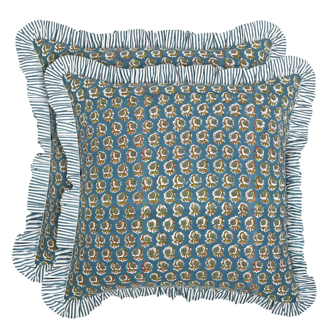 Decorative pillow with floral pattern and ruffled edge on a white background