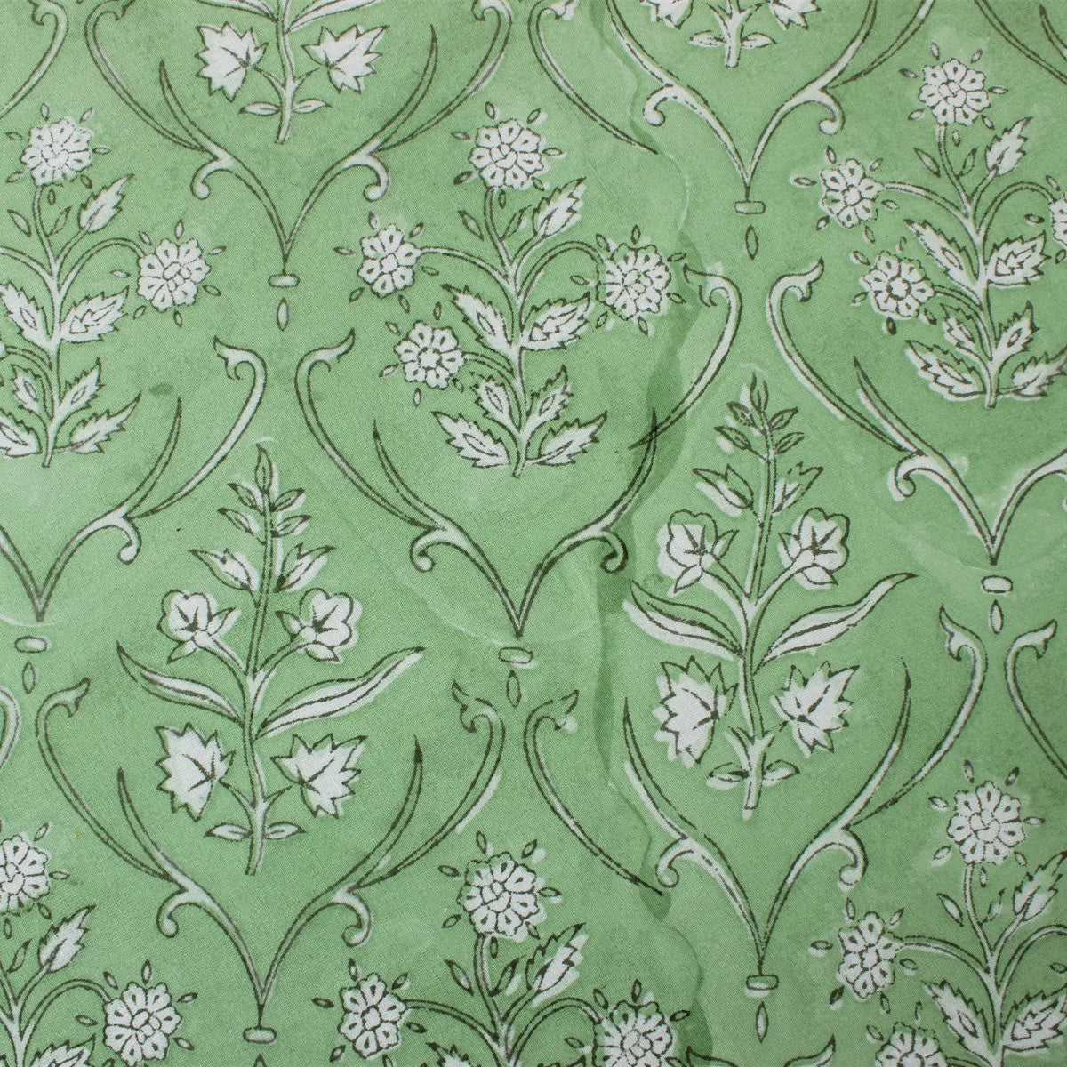 Floral pattern with white flowers and green leaves on a green background