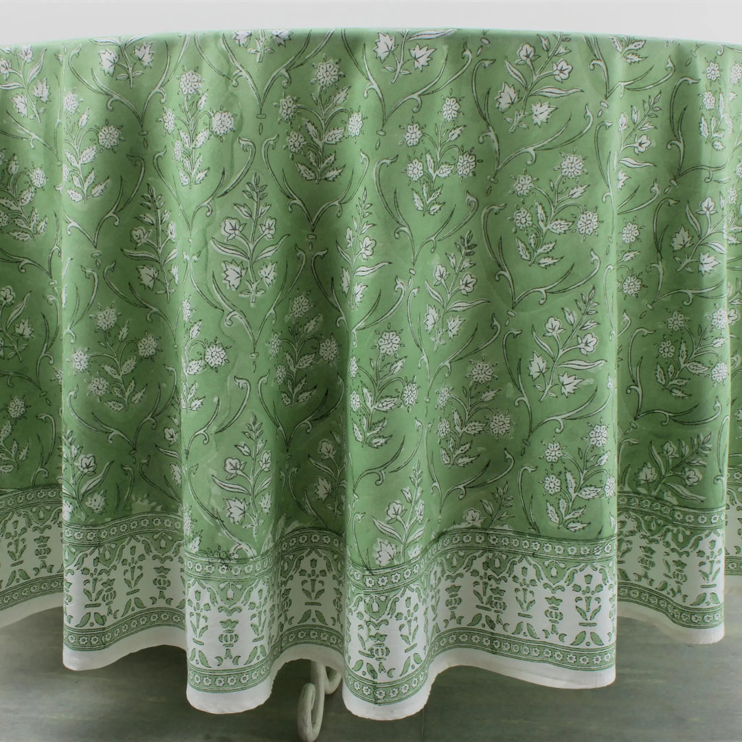 Green floral patterned tablecloth on a white background