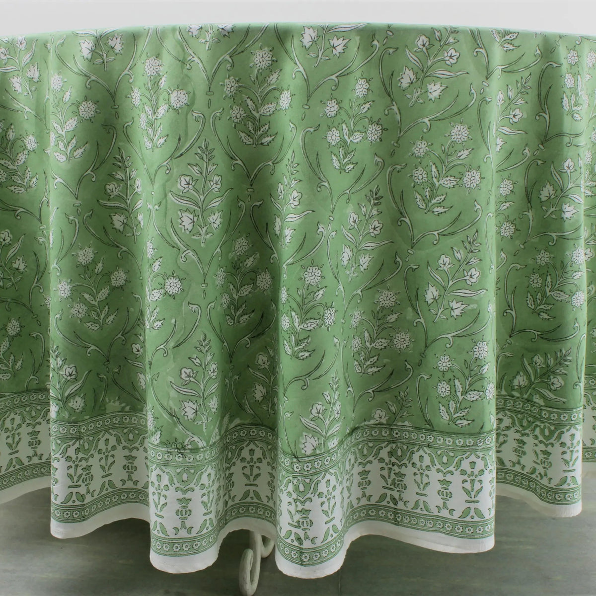 Green floral patterned tablecloth on a white background
