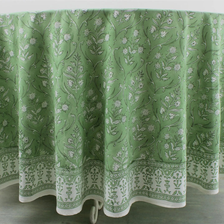 Green floral patterned tablecloth on a white background