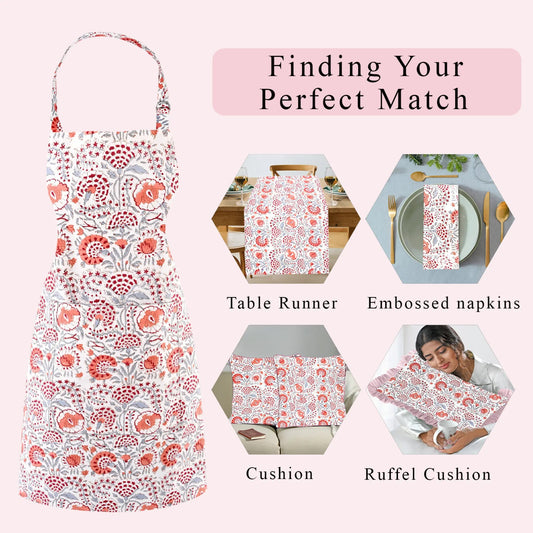 Floral apron with matching table runner, napkins, cushion, and ruffel cushion on a pink background.