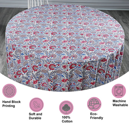 Round tablecloth with floral pattern on a wooden floor, featuring icons and text about material and care.