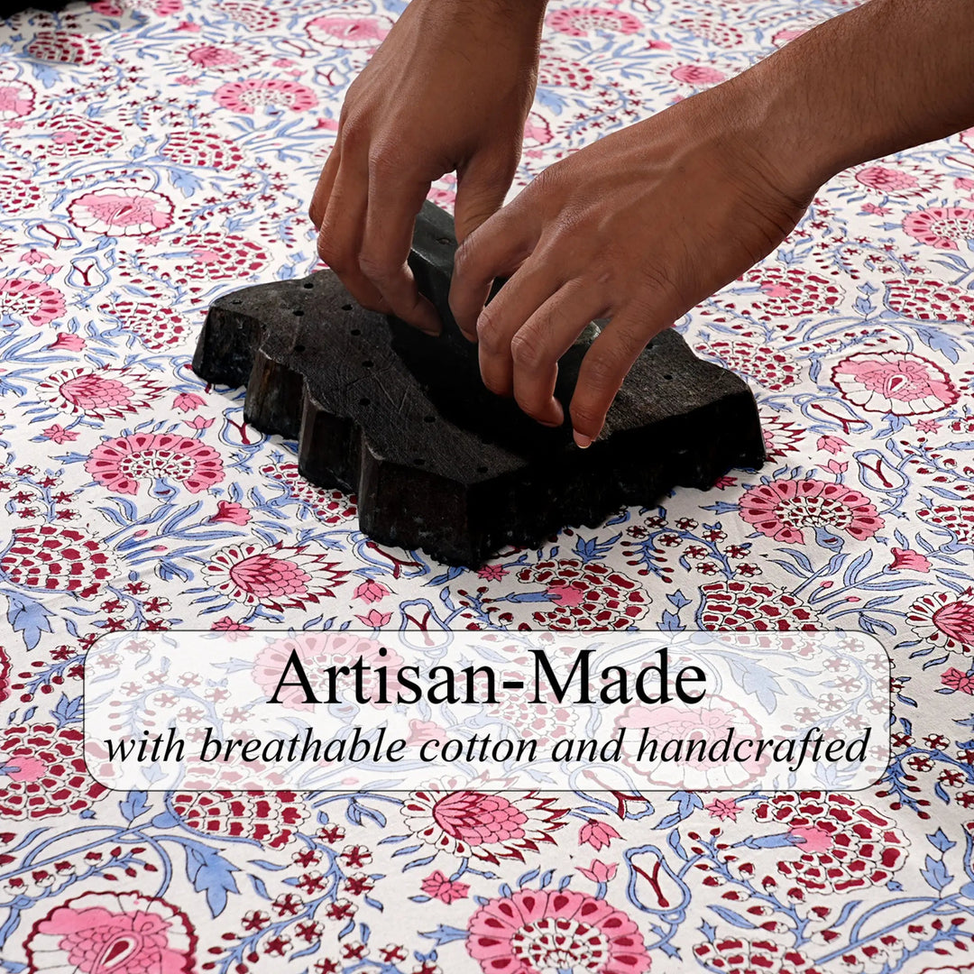 Hands working with black material on a floral fabric background, with text &