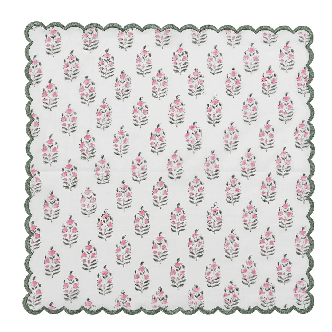 Floral patterned doily with scalloped edge on a white background
