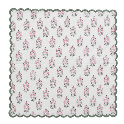 Floral patterned doily with scalloped edge on a white background