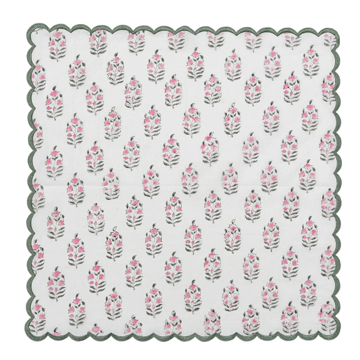 Floral patterned doily with scalloped edge on a white background
