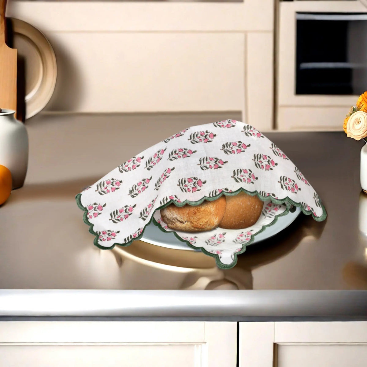 Floral-patterned cloth covering bread on a kitchen counter