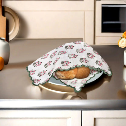 Floral-patterned cloth covering bread on a kitchen counter
