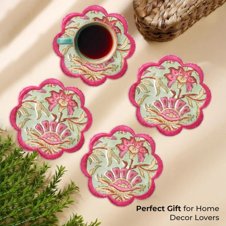 Set of floral coasters with a cup of tea on a beige surface, accompanied by text &