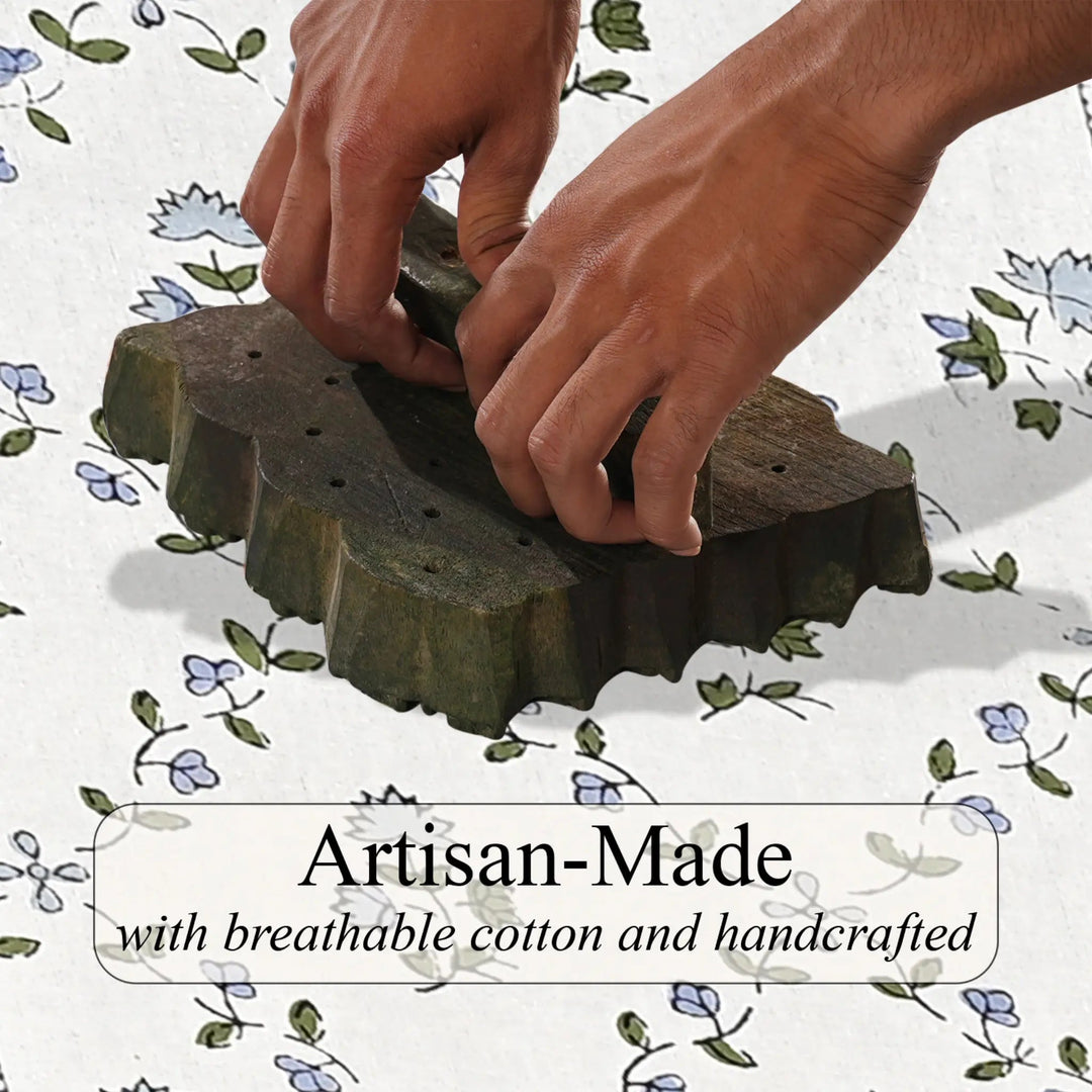 Hands working with a green woven product on a floral-patterned background, with text &