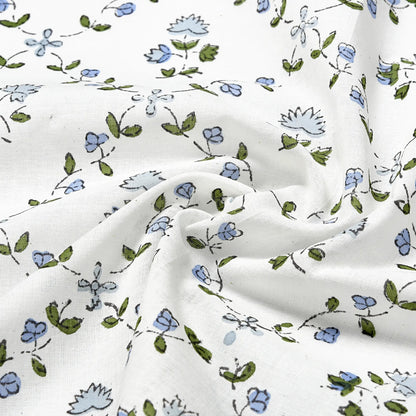 Floral patterned fabric with blue and green flowers on a white background