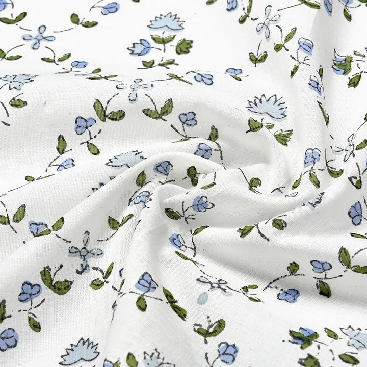 Floral patterned fabric with blue and green flowers on a white background