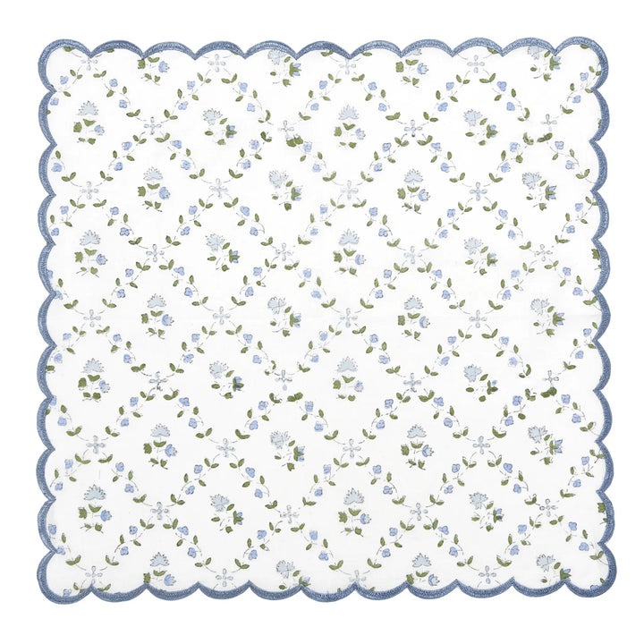 Floral patterned fabric swatch with scalloped edge on a white background
