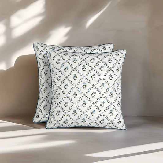 Two floral-patterned pillows on a neutral background