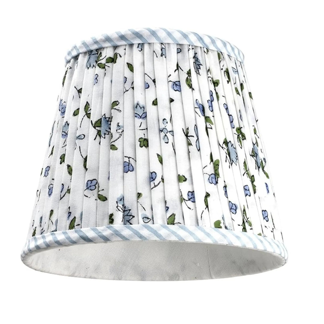 Floral patterned lampshade with blue stripes on a white background