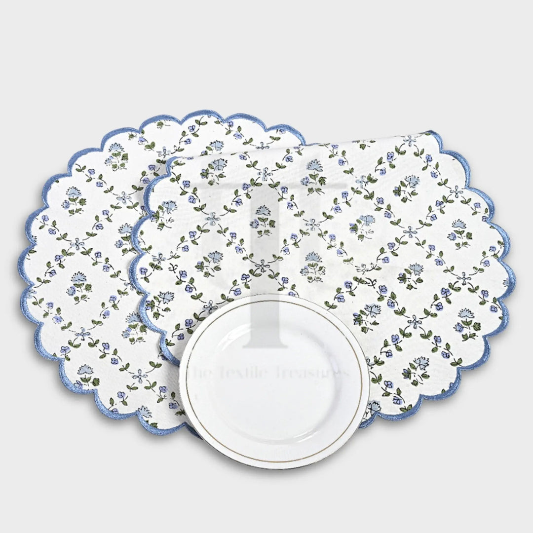 Floral-patterned placemat with scalloped edge on a white background