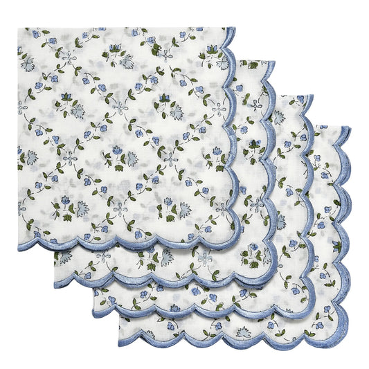 Set of floral table mats with scalloped edges on a white background