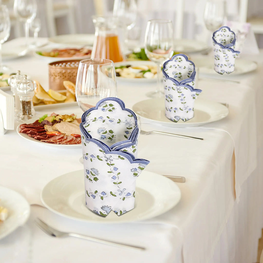 Decorative floral cups on a table with a meal setup