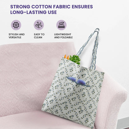 Floral tote bag on a pink couch with text about strong cotton fabric.