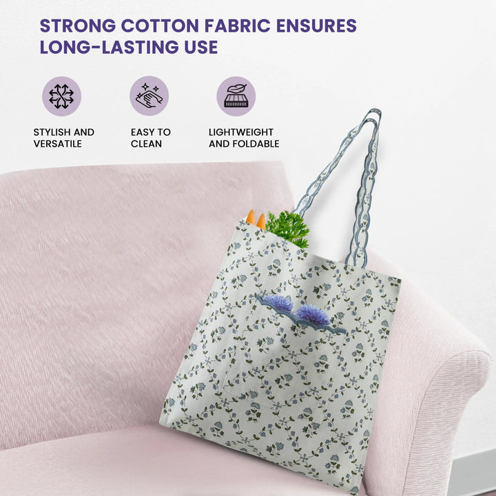 Floral tote bag on a pink couch with text about strong cotton fabric.