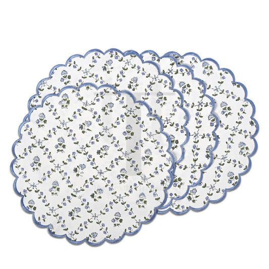 Set of three floral-patterned placemats with scalloped edges on a white background