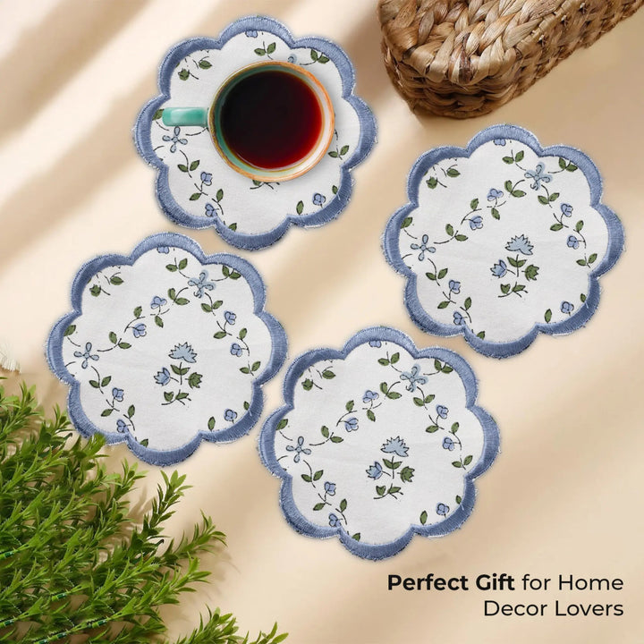 Set of floral coasters with a cup of coffee on a beige surface, accompanied by text &