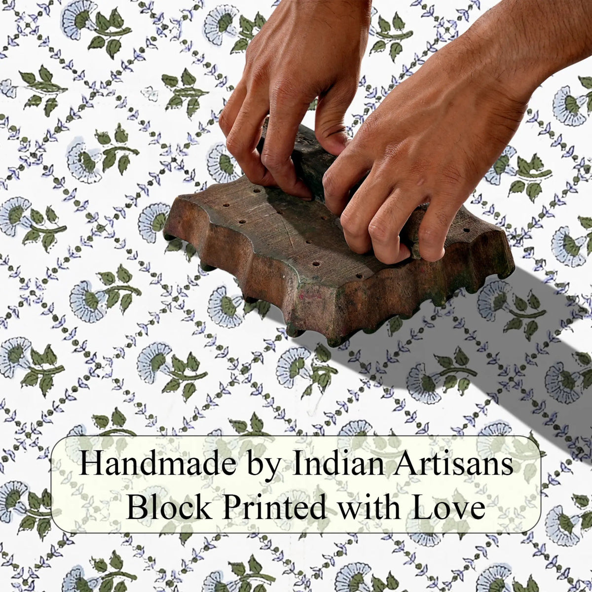 Hand block printing on fabric with text 'Handmade by Indian Artisans Block Printed with Love'.