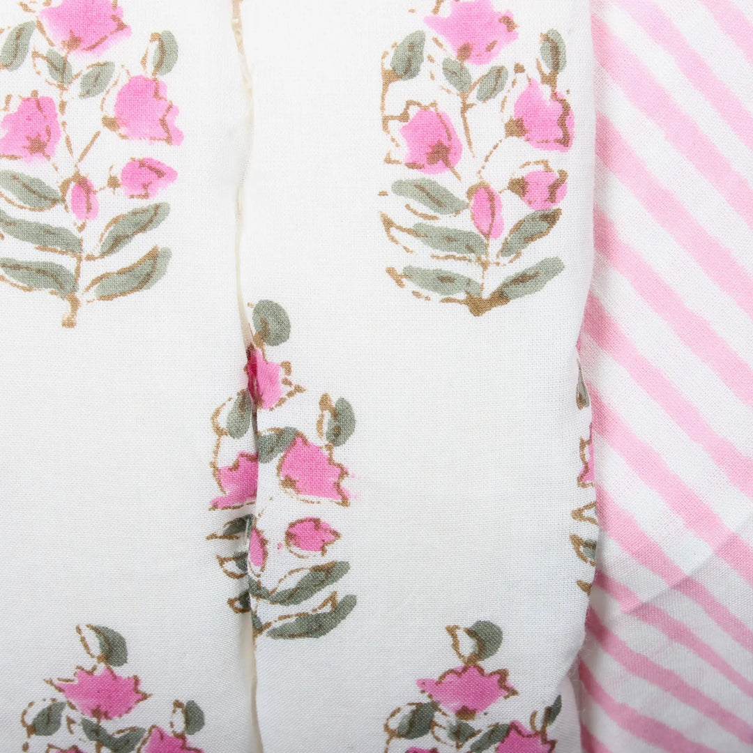 Two fabric swatches with floral pattern and pink stripes on a white background