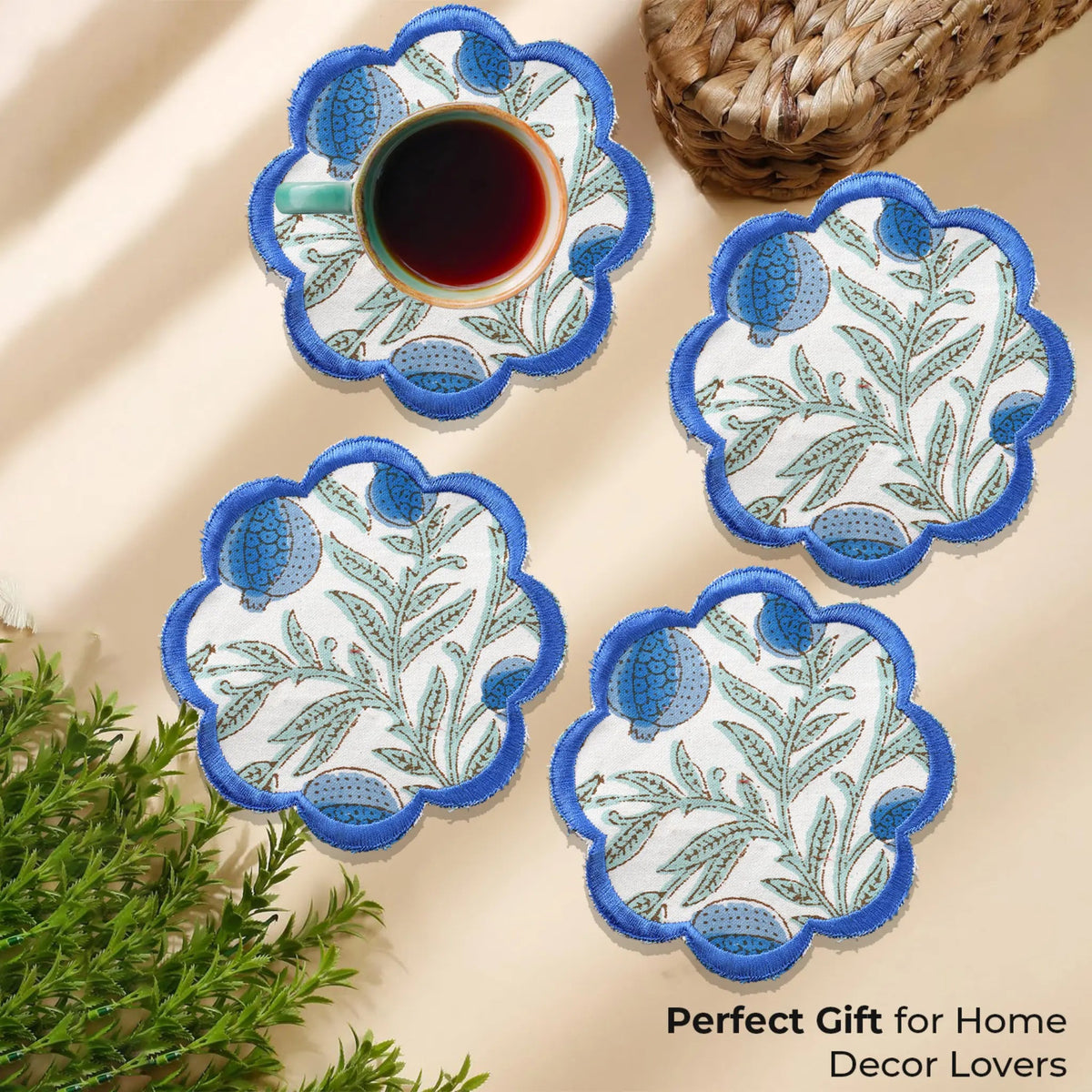 Set of four decorative coasters with floral patterns on a beige surface.