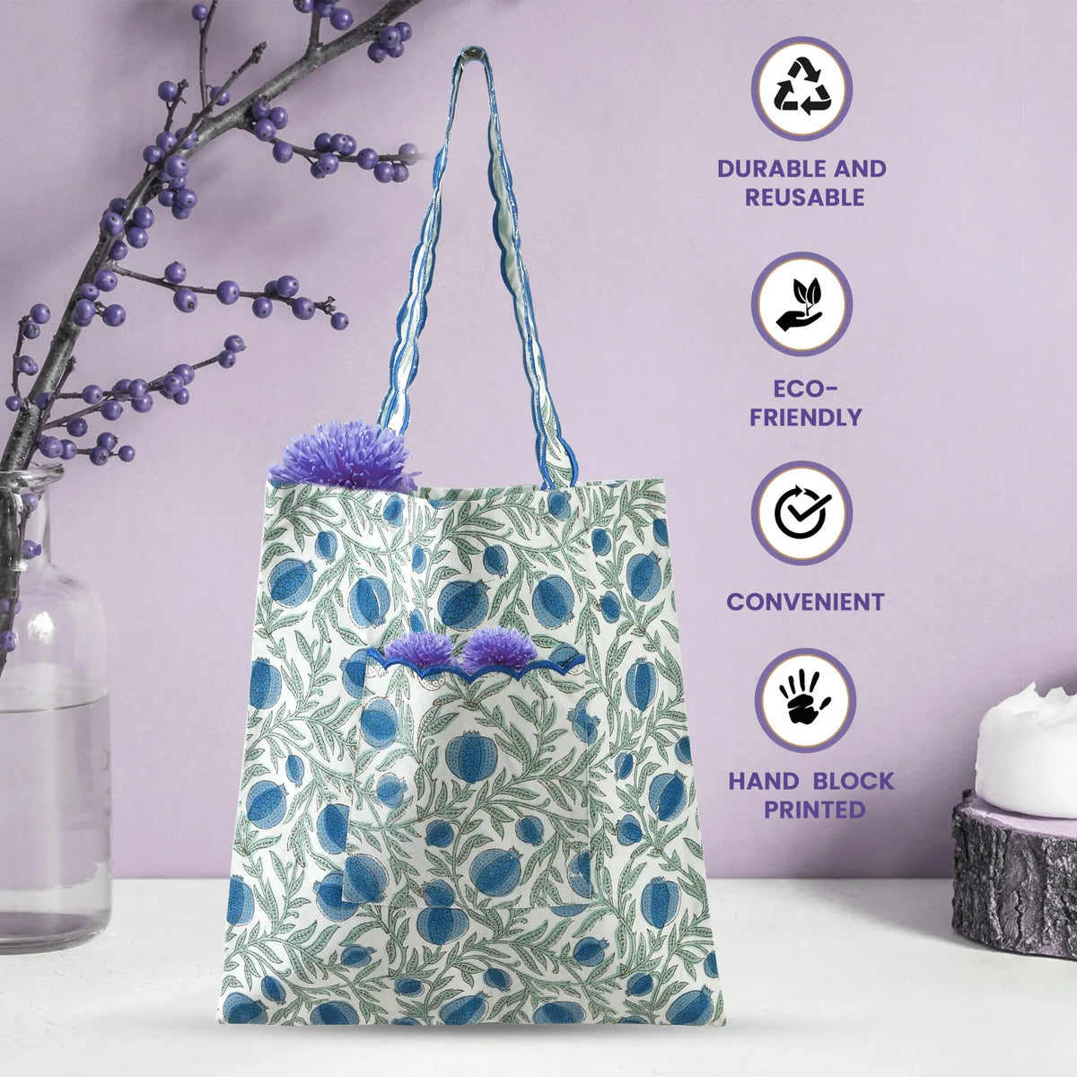 Floral tote bag with plants on a white surface and purple background, featuring eco-friendly icons.