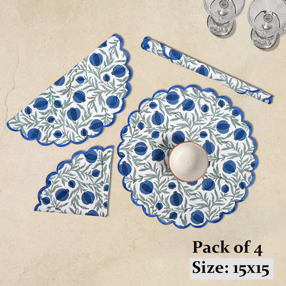 Set of four blue and white patterned placemats on a beige background