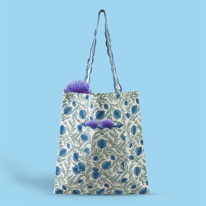 Floral-patterned tote bag with plants on a blue background