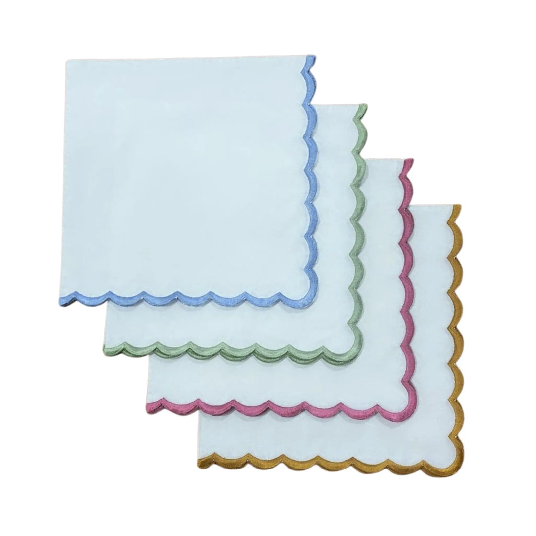 Set of three decorative napkins with colorful scalloped edges on a white background