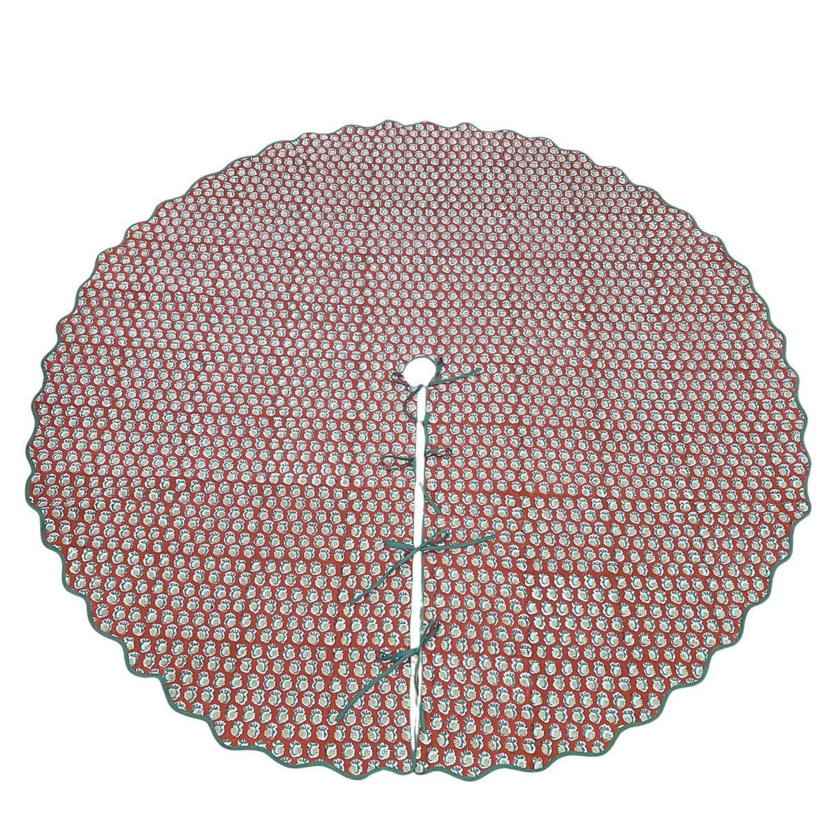 Round red and white patterned tree skirt on a white background