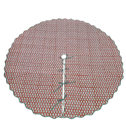 Round red and white patterned tree skirt on a white background