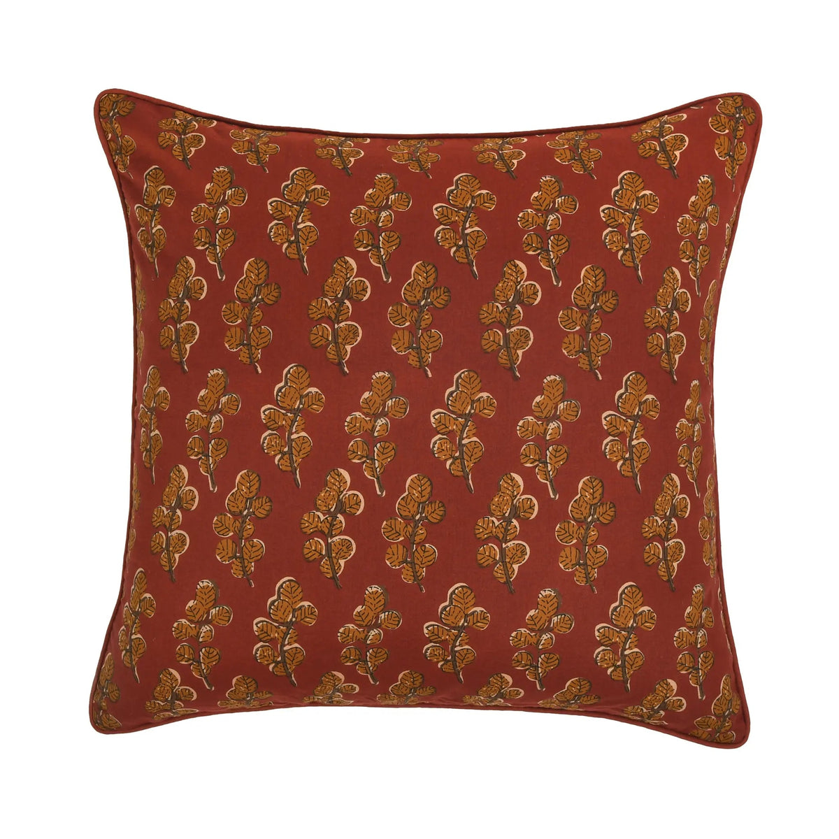 Red pillow with gold floral pattern on a white background