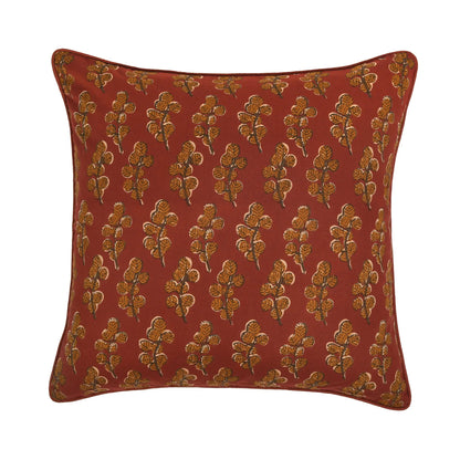 Red pillow with gold floral pattern on a white background