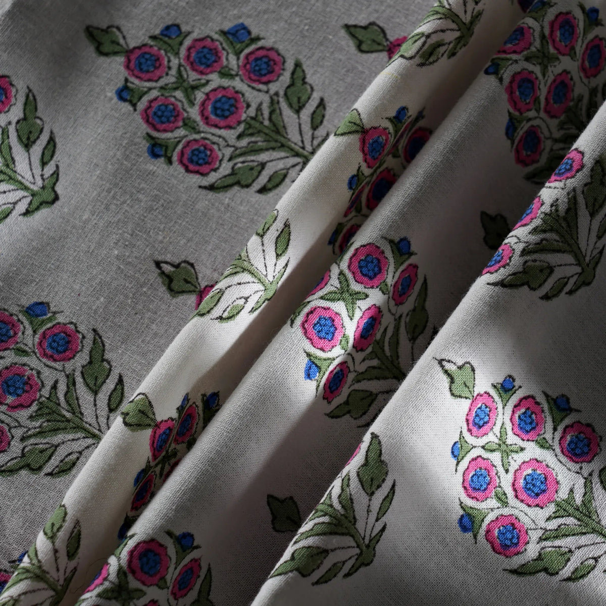 Fabric with floral embroidery pattern on a gray background
