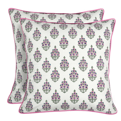 Two floral patterned pillows with pink accents on a white background