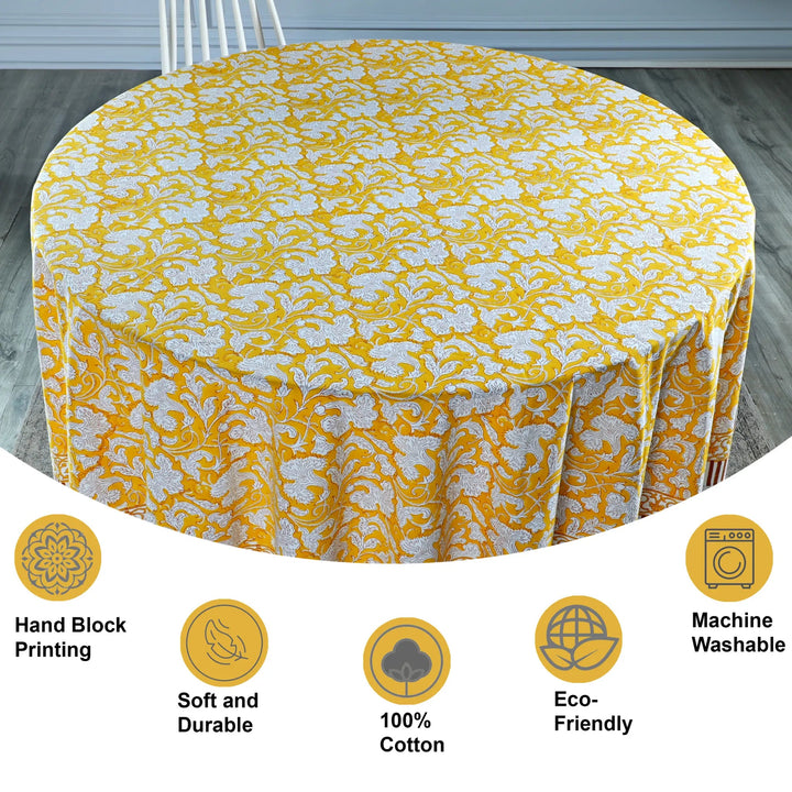 Yellow floral tablecloth on a round table with product features displayed below.
