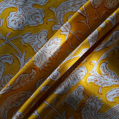 Yellow fabric with white floral patterns