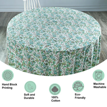 Floral patterned tablecloth on a round table with certification icons at the bottom.